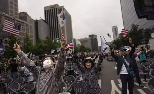 Members of a right-wing group supporting the U.S., wave South Korean and American flags while chanting slogans during a rally near the U.S. Embassy in Seoul, Saturday, May 25, 2024. (AP Photo/Jae C. Hong)