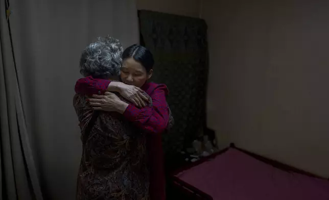 Yooree Kim, right, who was 11 when she was adopted from South Korea to a couple in France, hugs her biological mother, who had come to visit her in Seoul, South Korea, Friday, May 24, 2024. (AP Photo/Jae C. Hong)