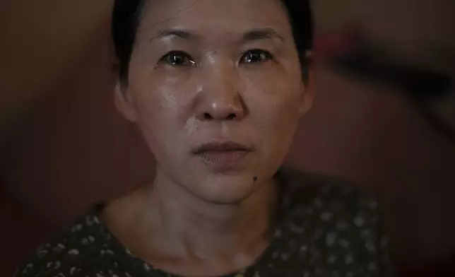 Yooree Kim, who was 11 when she was sent by an adoption agency to a couple in France, sits for a portrait as tears well up in her eyes in her apartment in Seoul, South Korea, Sunday, May 19, 2024. (AP Photo/Jae C. Hong)