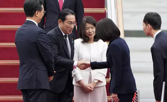 Japanese Prime Minister Fumio Kishida, second from left, is greeted as his wife Yuko Kishida stands upon their arrival at Seoul airbase in Seongnam, South Korea, Friday, Sept. 6, 2024. (AP Photo/Ahn Young-joon)