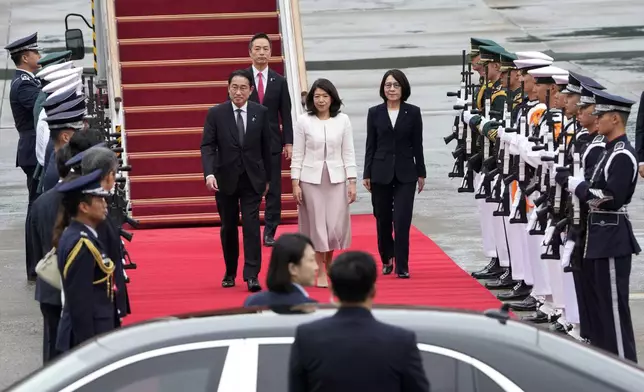 Japanese Prime Minister Fumio Kishida, center left, and his wife Yuko Kishida, center, inspect honor guards upon their arrival at Seoul air base in Seongnam, South Korea, Friday, Sept. 6, 2024. (AP Photo/Ahn Young-joon)