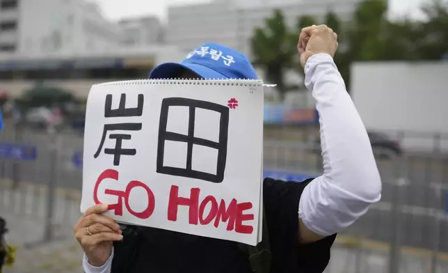 A protester shouts slogan with a sign reading "Kishida, Go Home" during a rally opposing a planned meeting between South Korean President Yoon Suk Yeol and Japanese Prime Minister Fumio Kishida near the Presidential Office in Seoul, South Korea, Friday, Sept. 6, 2024. (AP Photo/Lee Jin-man)