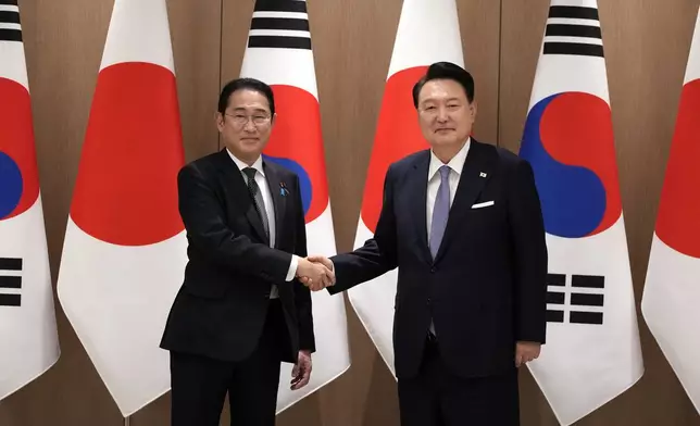 South Korean President Yoon Suk Yeol, right, and Japanese Prime Minister Fumio Kishida, left, shake hands during a meeting at the Presidential Office in Seoul, South Korea, Friday, Sept. 6, 2024. (AP Photo/Lee Jin-man, Pool)