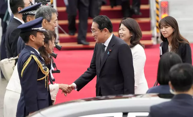 Japanese Prime Minister Fumio Kishida, center left, is greeted as his wife Yuko Kishida stands upon their arrival at Seoul airbase in Seongnam, South Korea, Friday, Sept. 6, 2024. (AP Photo/Ahn Young-joon)