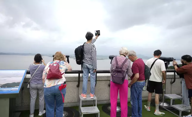 Visitors look at the North Korean side from the unification observatory in Paju, South Korea, Thursday, Sept. 5, 2024. (AP Photo/Lee Jin-man)