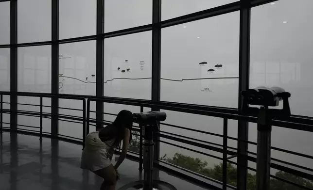 A visitor uses binoculars to see the North Korean side from the unification observatory in Paju, South Korea, Thursday, Sept. 5, 2024. (AP Photo/Lee Jin-man)