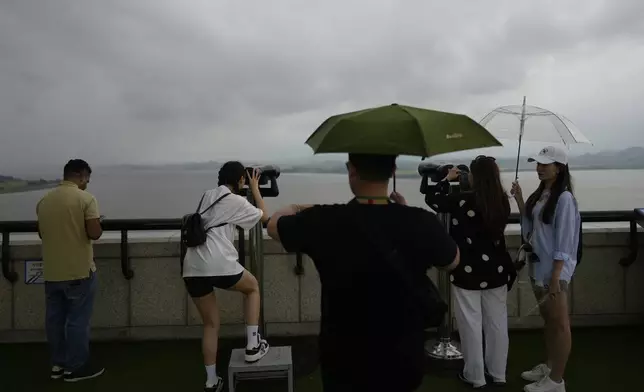 Visitors use binoculars to see the North Korean side from the unification observatory in Paju, South Korea, Thursday, Sept. 5, 2024. (AP Photo/Lee Jin-man)