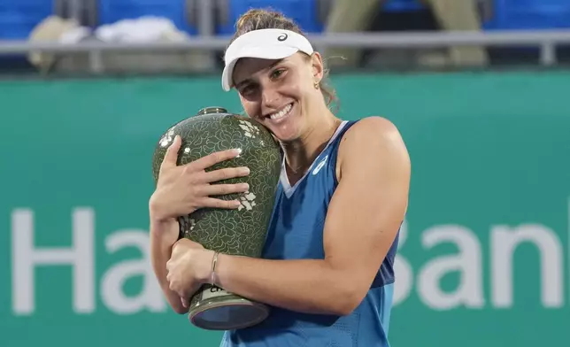 Beatriz Haddad Maia of Brazil holds her trophy after defeating Daria Kasatkina of Russia during their final match of the Korea Open tennis championships at Olympic Park Tennis Court in Seoul, South Korea, Sunday, Sept. 22, 2024. (AP Photo/Ahn Young-joon)