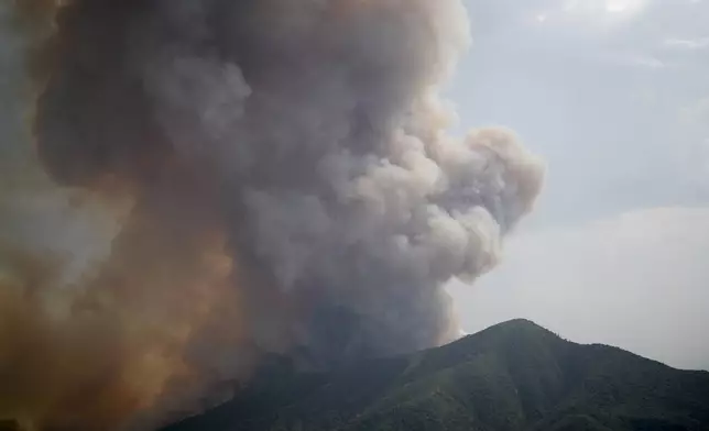 Smoke rises from the Line Fire over the mountains Saturday, Sept. 7, 2024, in Running Springs, Calif. (AP Photo/Eric Thayer)