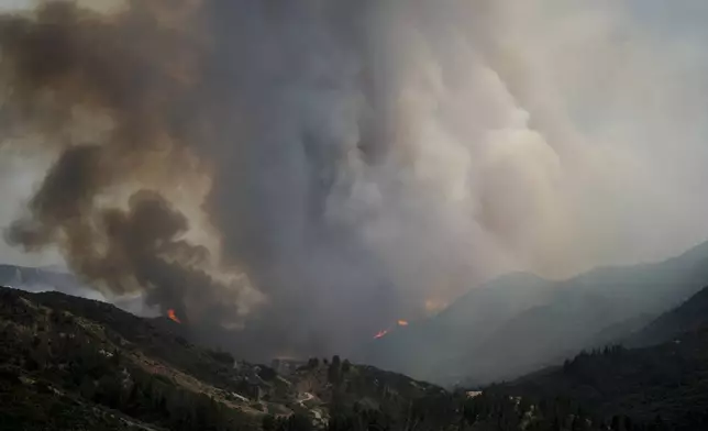 Smoke rises from the Line Fire over the mountains Saturday, Sept. 7, 2024, in Running Springs, Calif. (AP Photo/Eric Thayer)