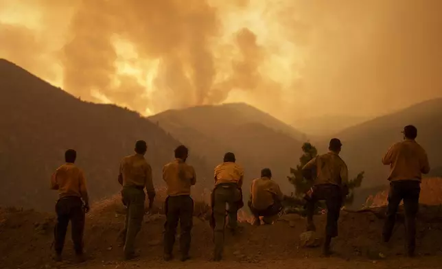 Firefighters monitor the advancing Line Fire in Angelus Oaks, Calif., Monday, Sept. 9, 2024. (AP Photo/Eric Thayer)