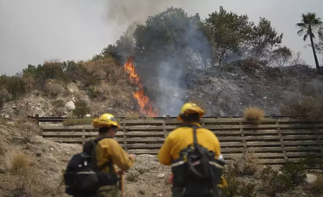 Fire crews monitor the Line Fire Saturday, Sept. 7, 2024, in Highland, Calif. (AP Photo/Eric Thayer)