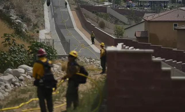 Fire crews monitor the Line Fire Saturday, Sept. 7, 2024, in Highland, Calif. (AP Photo/Eric Thayer)