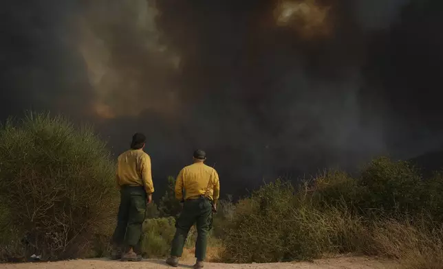 Fire crews monitor the Line Fire, Saturday, Sept. 7, 2024, in Running Springs, Calif. (AP Photo/Eric Thayer)