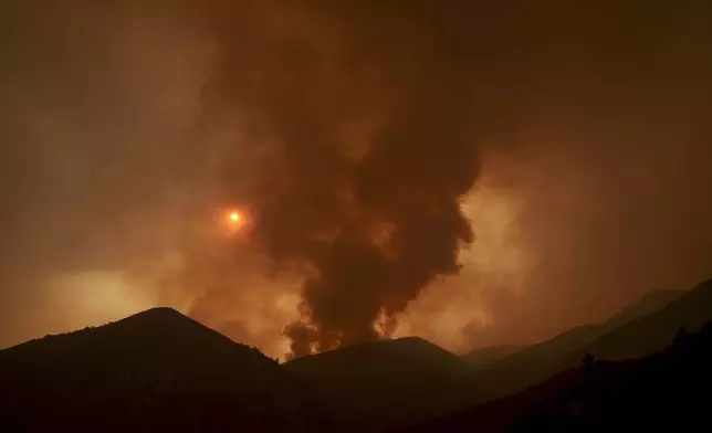 Smoke from the advancing Line Fire rises above a ridge in Angelus Oaks, Calif., Monday, Sept. 9, 2024. (AP Photo/Eric Thayer)