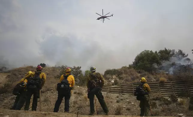 Fire crews monitor the Line Fire Saturday, Sept. 7, 2024, in Highland, Calif. (AP Photo/Eric Thayer)