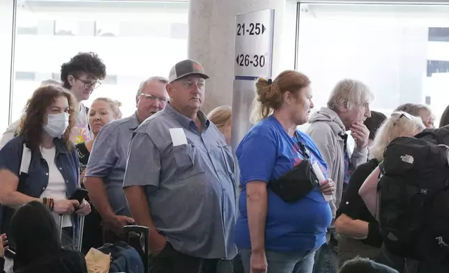 FILE - Travelers line up to board a Southwest Airlines plane at Love Field in Dallas, Thursday, July 25, 2024. (AP Photo/LM Otero, File)