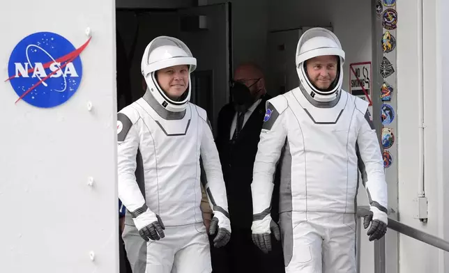 Roscosmos cosmonaut Aleksandr Gorbunov, left, and NASA astronaut Nick Hague leave the Operations and Checkout Building on their way to Launch Complex 40 for a mission to the International Space Station Saturday, Sept. 28, 2024 at Cape Canaveral, Fla., (AP Photo/John Raoux)