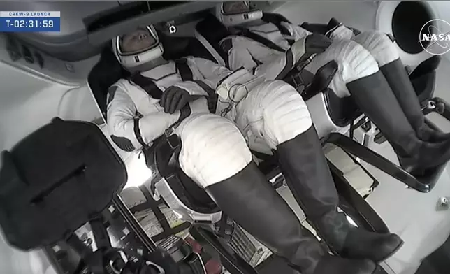 This image provided by NASA shows NASA astronaut Nick Hague and Roscosmos cosmonaut Aleksandr Gorbunov inside the SpaceX capsule Saturday, Sept. 28, 2024, at the Kennedy Space Center in Cape Canaveral, Fla. (NASA via AP)