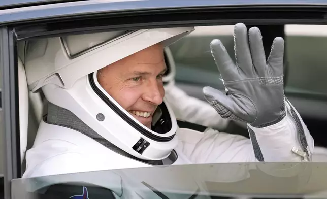 NASA astronaut Nick Hague waves as he leaves the Operations and Checkout building for a trip to the launch pad 40 Saturday, Sept. 28, 2024, at the Kennedy Space Center in Cape Canaveral, Fla. (AP Photo/Chris O'Meara)