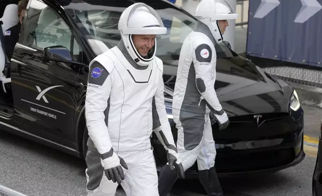 NASA astronaut Nick Hague, left, and Roscosmos cosmonaut Aleksandr Gorbunov leave the Operations and Checkout building for a trip to the launch pad 40 Saturday, Sept. 28, 2024, at the Kennedy Space Center in Cape Canaveral, Fla. (AP Photo/Chris O'Meara)