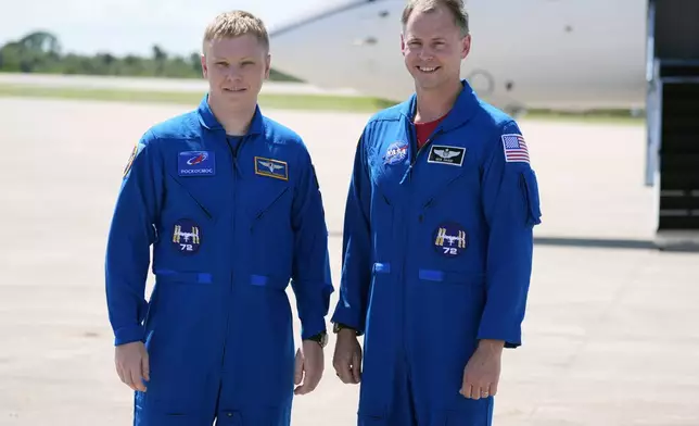 Roscosmos cosmonaut Aleksandr Gorbunov, left, and NASA astronaut Nick Hague pose for a photo after they arrived at the Kennedy Space Center in Cape Canaveral, Fla., Saturday, Sept. 21, 2024 to prepare for their mission to the International Space Station. (AP Photo/John Raoux)