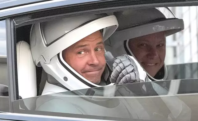 NASA astronaut Nick Hague, left, and Roscosmos cosmonaut Aleksandr Gorbunov, left, gives a thumbs up as they leave the Operations and Checkout Building on their way to Launch Complex 40 for a mission to the International Space Station Saturday, Sept. 28, 2024 at Cape Canaveral, Fla., (AP Photo/John Raoux)