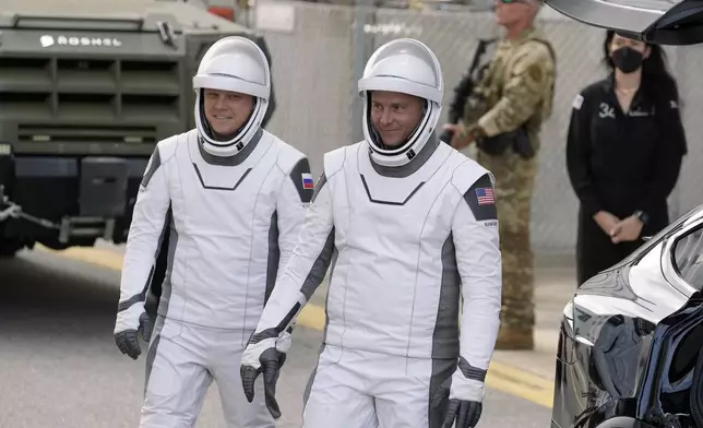 NASA astronaut Nick Hague, right, and Roscosmos cosmonaut Aleksandr Gorbunov leave the Operations and Checkout building for a trip to the launch pad 40 Saturday, Sept. 28, 2024, at the Kennedy Space Center in Cape Canaveral, Fla. (AP Photo/Chris O'Meara)