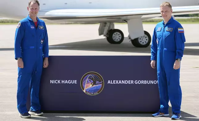 NASA astronaut Nick Hague, left, and Roscosmos cosmonaut Aleksandr Gorbunov pose for a photo after they arrived at the Kennedy Space Center in Cape Canaveral, Fla., Saturday, Sept. 21, 2024 as they prepare for their mission to the International Space Station. (AP Photo/John Raoux)