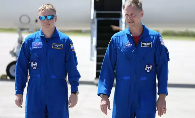 Roscosmos cosmonaut Aleksandr Gorbunov, left, and NASA astronaut Nick Hague arrive at the Kennedy Space Center in Cape Canaveral, Fla., Saturday, Sept. 21, 2024 as they prepare for their mission to the International Space Station. (AP Photo/John Raoux)