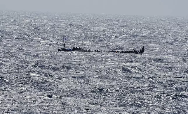 FILE - Unauthorized migrants crowd a wooden boat as they sail to the port in La Restinga on the Canary island of El Hierro, Spain, on Aug. 18, 2024. (AP Photo/Maria Ximena, File)