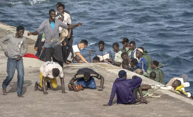 FILE - Unauthorized migrants react as they arrive at the port in La Restinga on the Canary island of El Hierro, Spain, on, Aug. 19, 2024. (AP Photo/Maria Ximena, File)