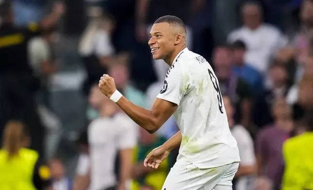 Real Madrid's Kylian Mbappe celebrates after scoring the opening goal during the Champions League opening phase soccer match between Real Madrid and VfB Stuttgart at the Santiago Bernabeu stadium, in Madrid, Tuesday, Sept. 17, 2024. (AP Photo/Manu Fernandez)