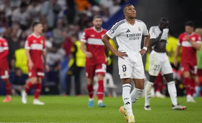 Real Madrid's Kylian Mbappe walks along the pitch after Stuttgart score its side's first goal during the Champions League opening phase soccer match between Real Madrid and VfB Stuttgart at the Santiago Bernabeu stadium, in Madrid, Tuesday, Sept. 17, 2024. (AP Photo/Manu Fernandez)