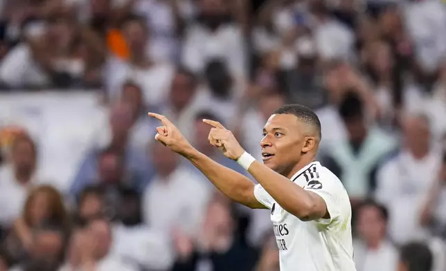 Real Madrid's Kylian Mbappe celebrates after scoring the opening goal during the Champions League opening phase soccer match between Real Madrid and VfB Stuttgart at the Santiago Bernabeu stadium, in Madrid, Tuesday, Sept. 17, 2024. Real Madrid won 3-1. (AP Photo/Manu Fernandez)