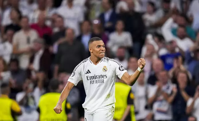 Real Madrid's Kylian Mbappe celebrates after scoring the opening goal during the Champions League opening phase soccer match between Real Madrid and VfB Stuttgart at the Santiago Bernabeu stadium, in Madrid, Tuesday, Sept. 17, 2024. (AP Photo/Manu Fernandez)