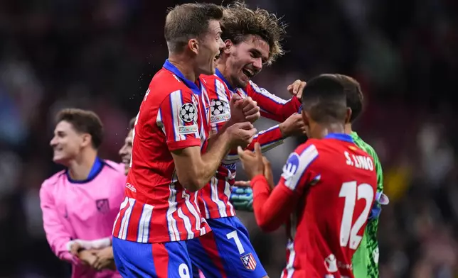 Atletico Madrid's Antoine Griezmann, center, with teammates at the end of the Champions League opening phase soccer match between Atletico Madrid and RB Leipzig at the Metropolitano stadium, in Madrid, Thursday, Sept. 19, 2024. Atletico Madrid won 2-1. (AP Photo/Manu Fernandez)