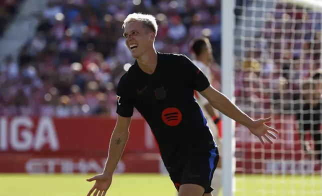 Barcelona's Dani Olmo celebrates after scoring his side's third goal during the Spanish La Liga soccer match between Girona and Barcelona at the Montilivi stadium in Girona, Spain, Sunday, Sept. 15, 2024. (AP Photo/Joan Monfort)