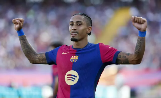 Barcelona's Raphinha celebrates scoring his side's 4th goal during the Spanish La Liga soccer match between FC Barcelona and Valladolid at the Olympic stadium in Barcelona, Spain, Saturday, Aug. 31, 2024. (AP Photo/Joan Monfort)