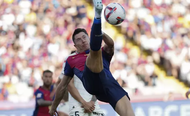 Barcelona's Robert Lewandowski tries a bicycle kick during the Spanish La Liga soccer match between FC Barcelona and Valladolid at the Olympic stadium in Barcelona, Spain, Saturday, Aug. 31, 2024. (AP Photo/Joan Monfort)