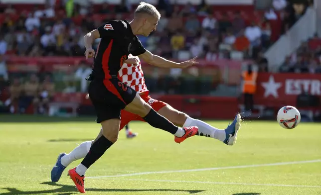 Barcelona's Dani Olmo scores his side's third goal during the Spanish La Liga soccer match between Girona and Barcelona at the Montilivi stadium in Girona, Spain, Sunday, Sept. 15, 2024. (AP Photo/Joan Monfort)