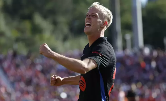 Barcelona's Dani Olmo celebrates after scoring his side's third goal during the Spanish La Liga soccer match between Girona and Barcelona at the Montilivi stadium in Girona, Spain, Sunday, Sept. 15, 2024. (AP Photo/Joan Monfort)