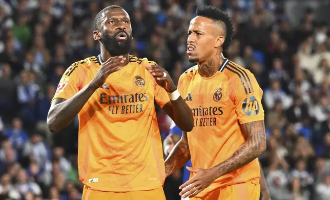 Real Madrid's Antonio Rudiger, left and Real Madrid's Eder Militao react during a Spanish La Liga soccer match between Real Sociedad and Real Madrid at the Reale Arena in San Sebastian, Spain, Saturday, Sept. 14, 2024. (AP Photo/Miguel Oses)