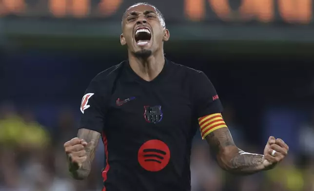 Barcelona's Raphinha celebrates after scoring his side's 4th goal against Villarreal during a Spanish La Liga soccer match at the La Cerámica stadium in Villarreal, Spain, Sunday, Sept. 22, 2024. (AP Photo/Alberto Saiz)