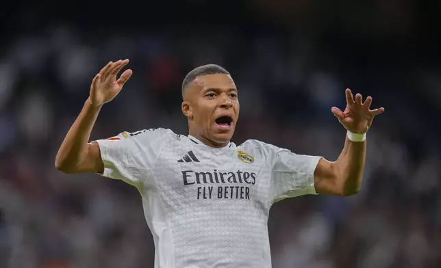 Real Madrid's Kylian Mbappe celebrates after scoring his side's second goal during a Spanish La Liga soccer match between Real Madrid and Alaves at Santiago Bernabeu stadium in Madrid, Spain, Tuesday, Sept. 24, 2024. (AP Photo/Manu Fernandez)