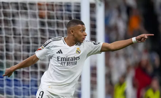 Real Madrid's Kylian Mbappe celebrates after scores a disallowed goal during a Spanish La Liga soccer match between Real Madrid and Alaves at Santiago Bernabeu stadium in Madrid, Spain, Tuesday, Sept. 24, 2024. (AP Photo/Manu Fernandez)