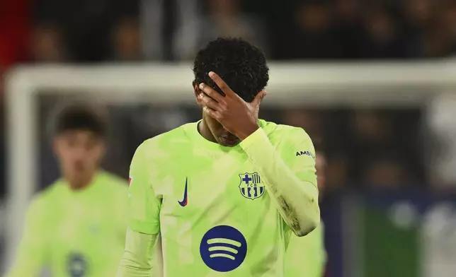 Barcelona's Lamine Yamal reacts at the end of a Spanish La Liga soccer match after loosing against Osasuna at El Sadar stadium in Pamplona, Spain, Saturday, Sept. 28, 2024. (AP Photo/Miguel Oses)