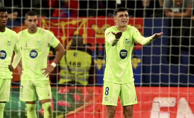 Barcelona's Pedri reacts during a Spanish La Liga soccer match between Osasuna and Barcelona at El Sadar stadium in Pamplona, Spain, Saturday, Sept. 28, 2024. (AP Photo/Miguel Oses)