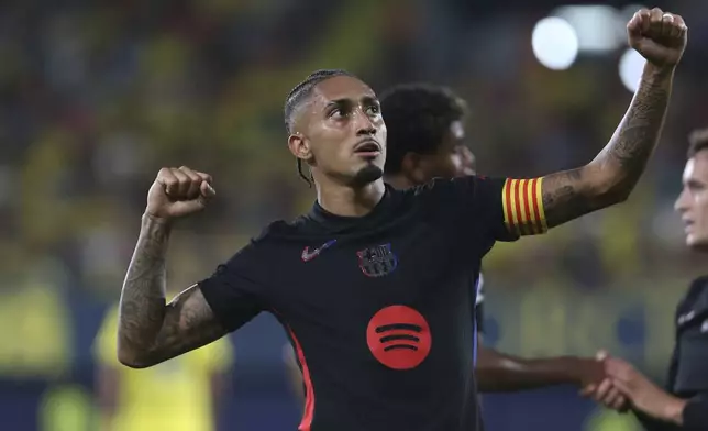 Barcelona's Raphinha celebrates scoring his side's 4th goal against Villarreal during a Spanish La Liga soccer match at the La Cerámica stadium in Villarreal, Spain, Sunday, Sept. 22, 2024. (AP Photo/Alberto Saiz)