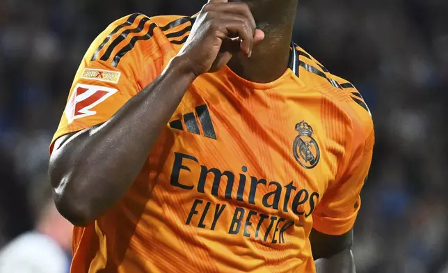 Real Madrid's Vinicius Junior celebrates after scoring the opening goal with a penalty kick during a Spanish La Liga soccer match between Real Sociedad and Real Madrid at the Reale Arena in San Sebastian, Spain, Saturday, Sept. 14, 2024. (AP Photo/Miguel Oses)